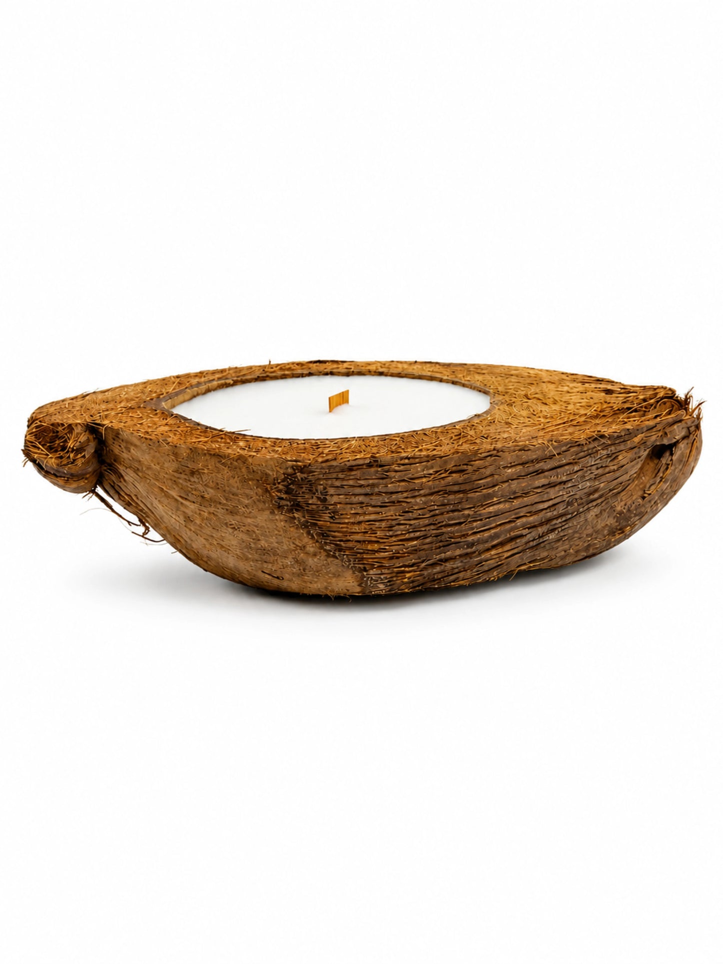 A natural half coconut shell scented soy wax candle with white soy wax and a wooden wick, featuring a minimalist organic design, named 'MPATZAKA COCONUT BLISS SCENTED CANDLE'.